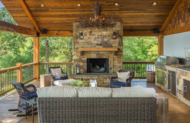 Outdoor kitchen with large stone fireplace