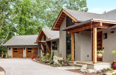 Custom home with wood and stucco driveway