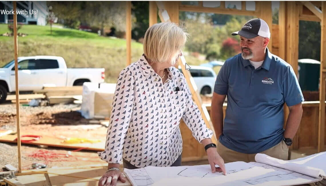 Brian Sineath and interior designer talking about plans on job site