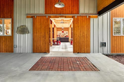 Front entrance of art building with open barn doors looking through the building to the back