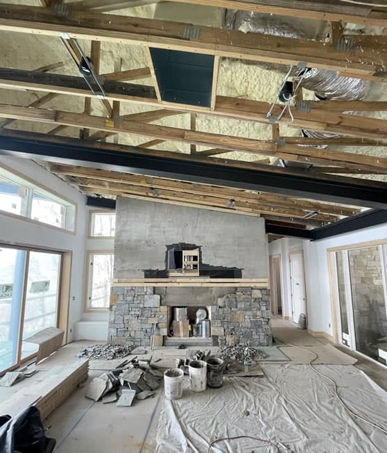 Construction in process: Exposed beams and fireplace in great room